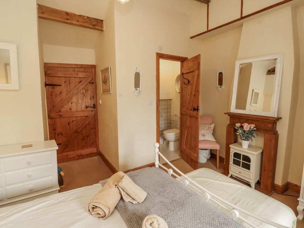 A bedroom with a bed and wardrobe at White House in Shap