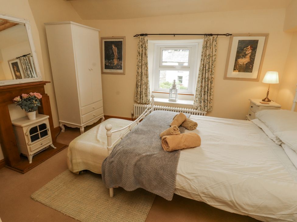 A bedroom with a bed and wardrobe at White House in Shap