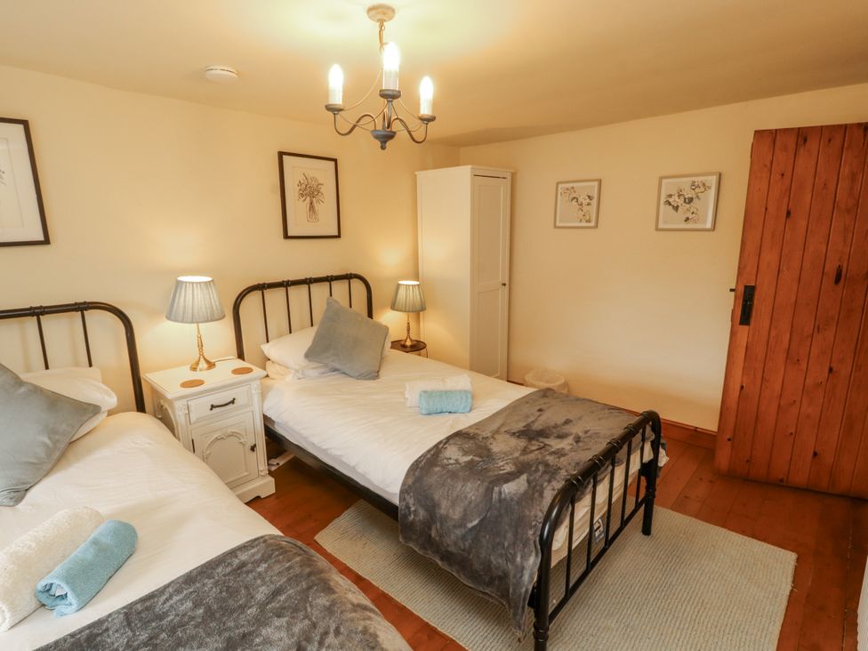 A bedroom with two beds and nightstands at White House in Shap