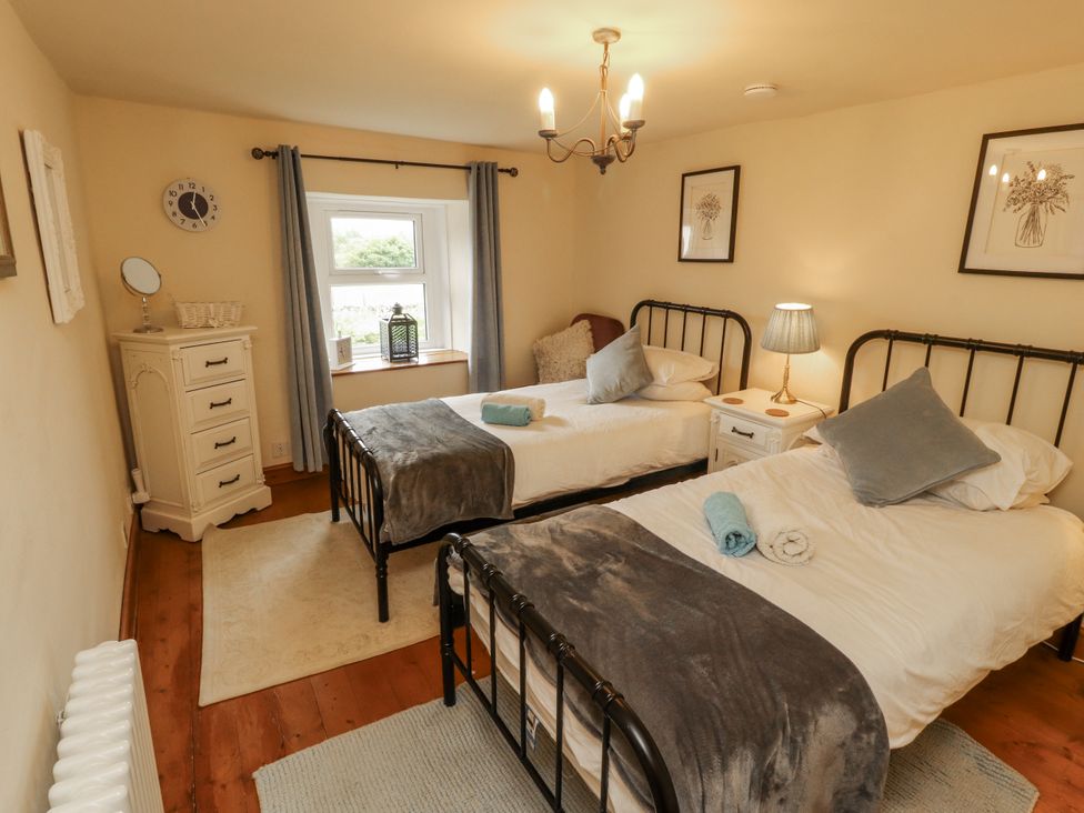 A bedroom with two beds and a window at White House in Shap