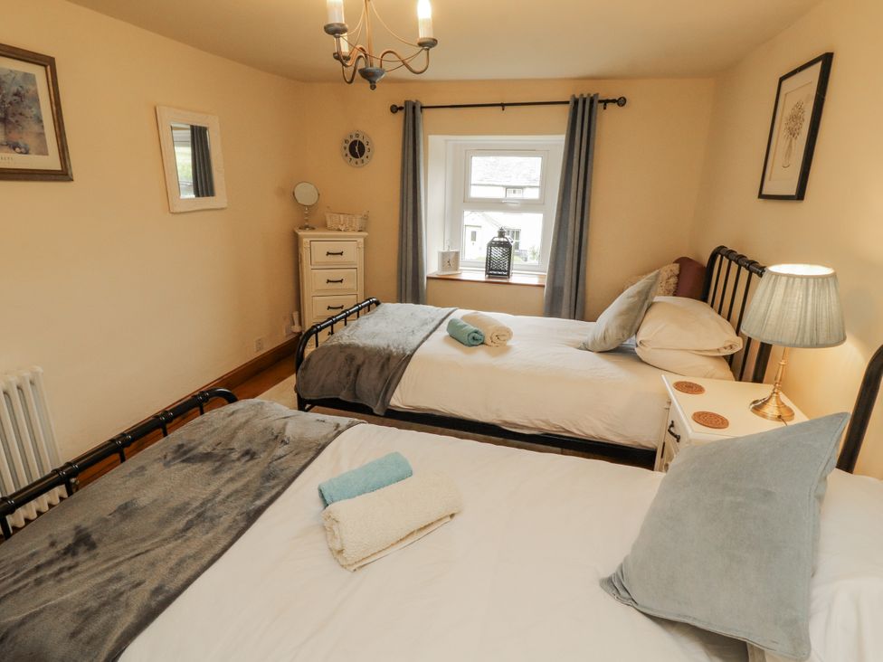 A bedroom with two beds and a dresser at White House in Shap