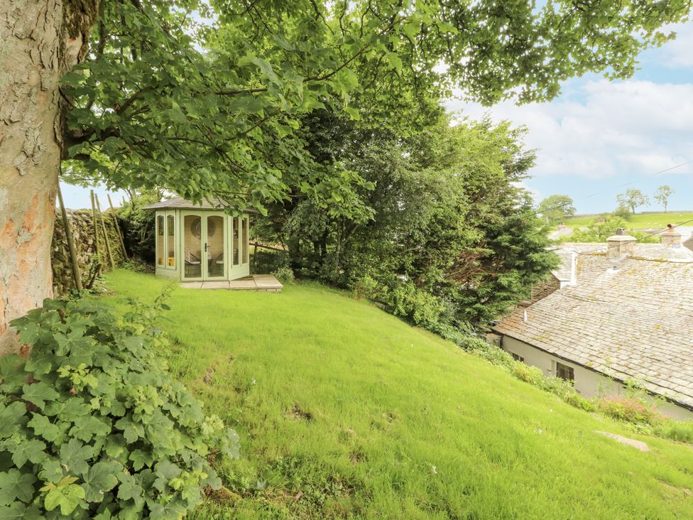 A garden with a summerhouse and greenery at White House in Shap