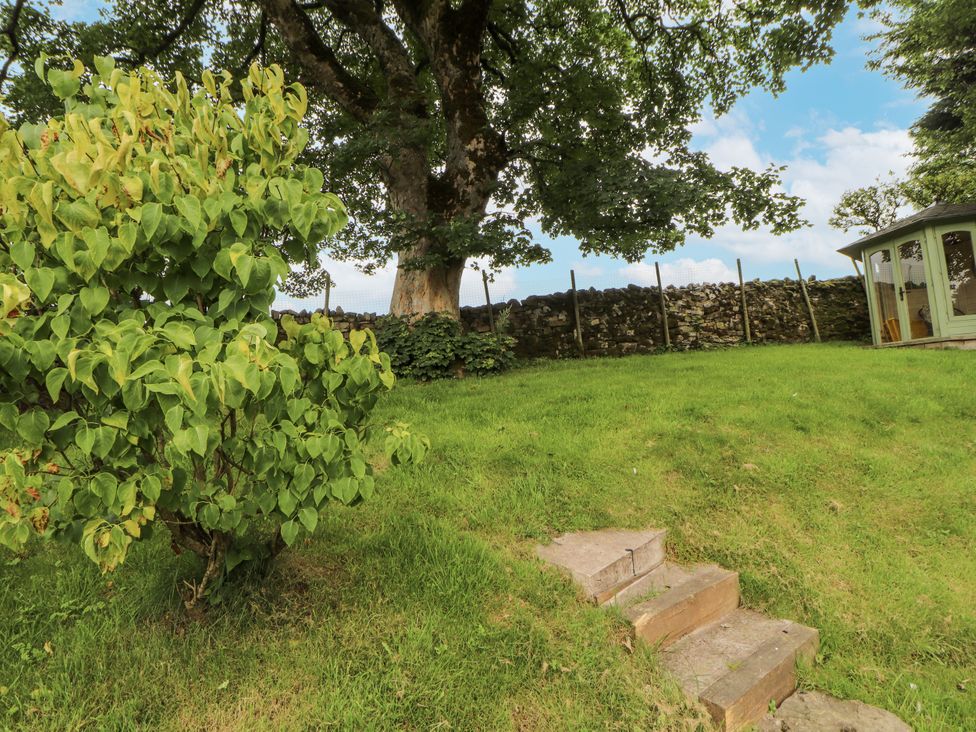 A garden with grass and a tree at White House in Shap