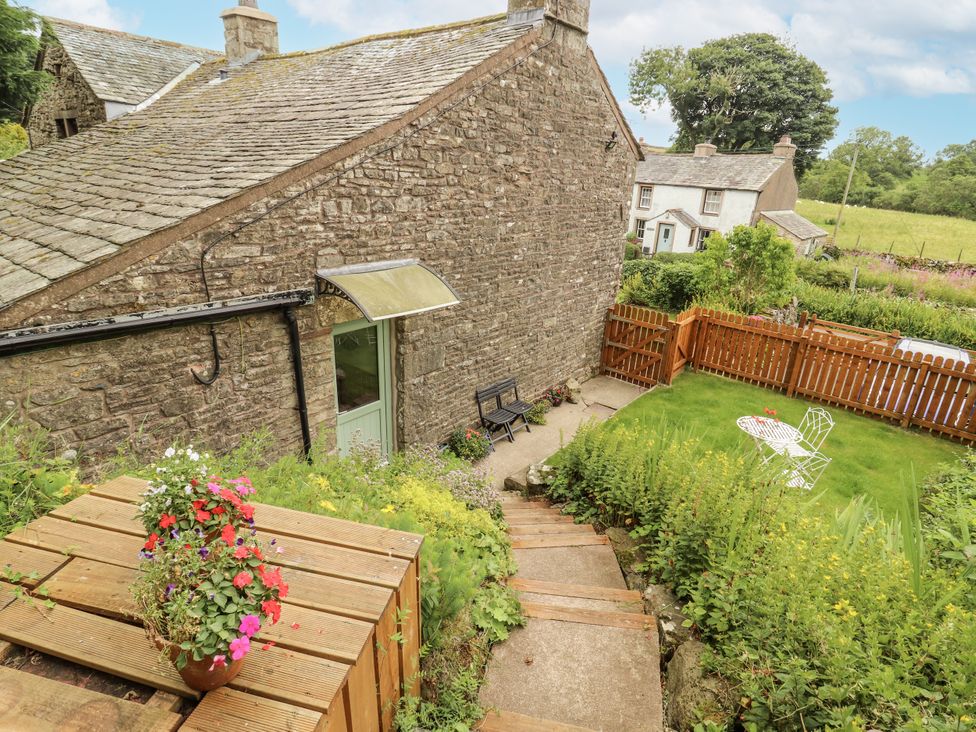 An outdoor garden area with steps and seating at White House in Shap