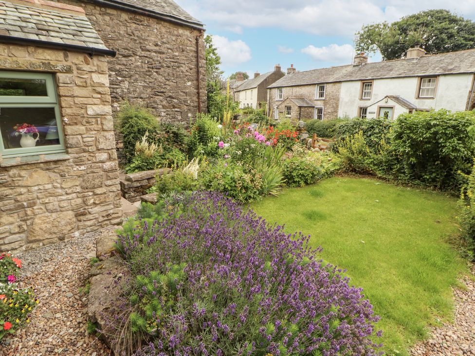 A garden with flowers and a pathway at White House in Shap