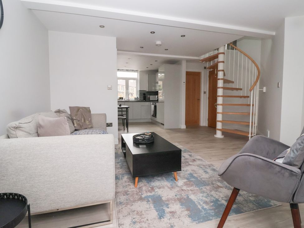 A living room with a coffee table and staircase at Moor View in Skipton