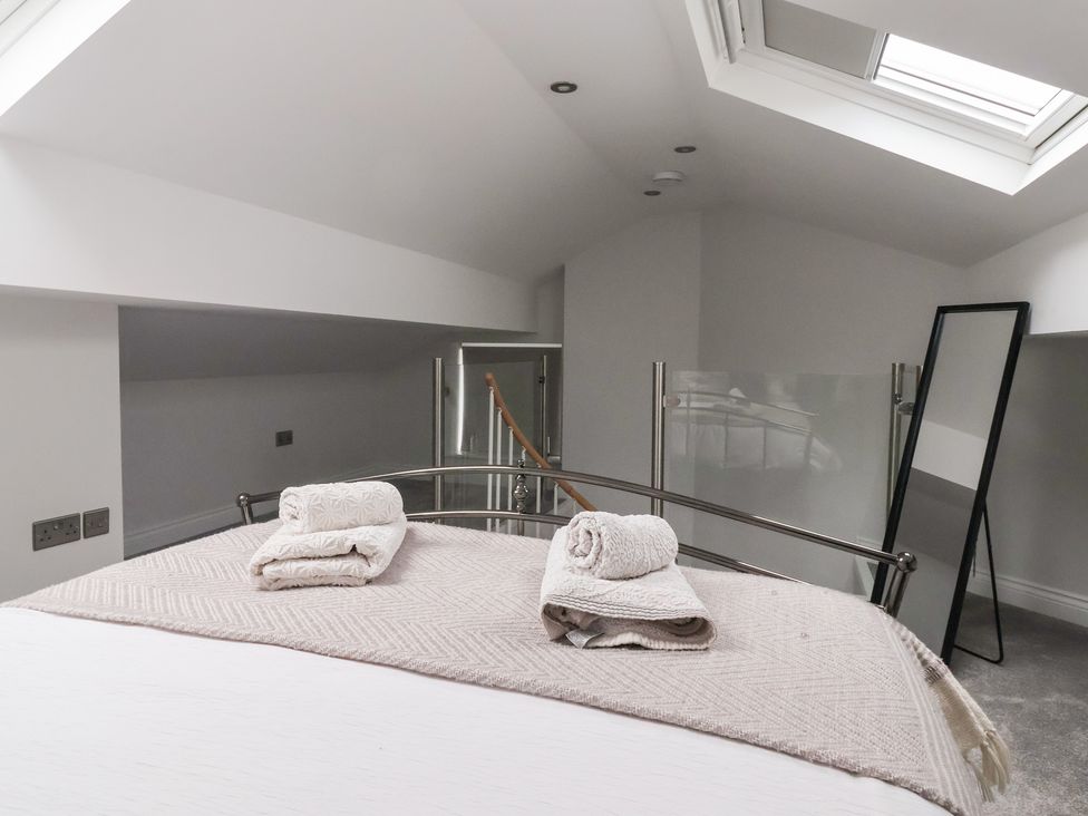 A bedroom with a bed and towels on top at Moor View in Skipton
