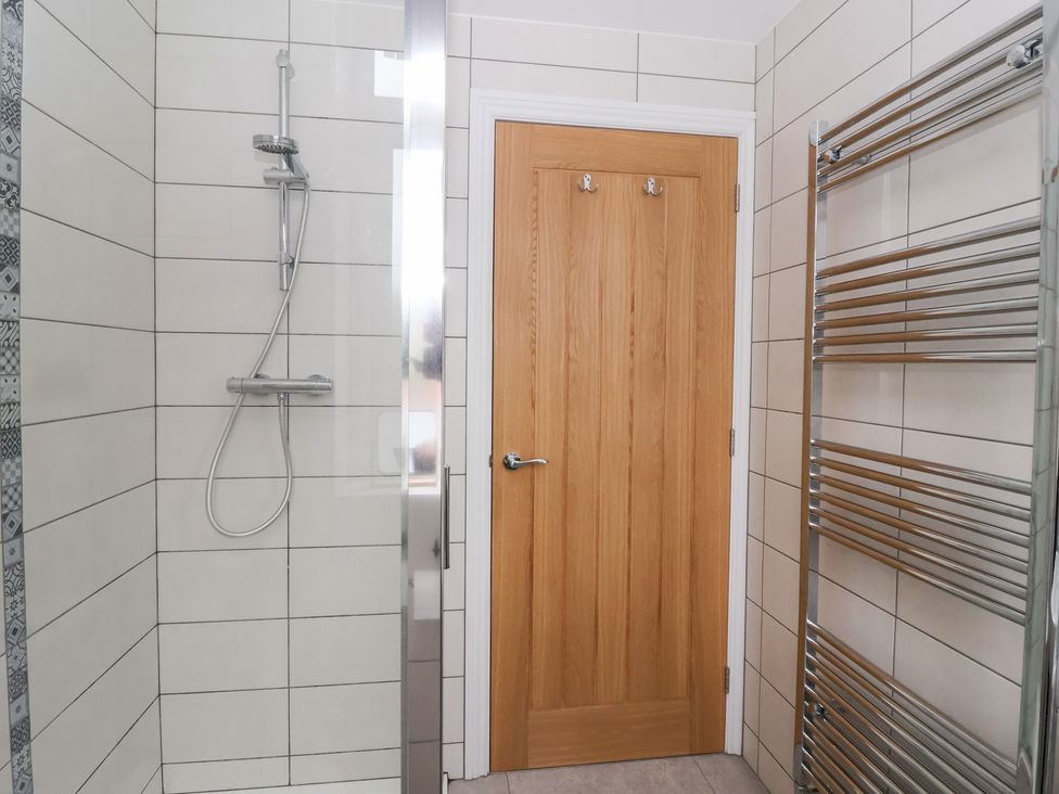 A bathroom with a shower and towel rail at Moor View in Skipton