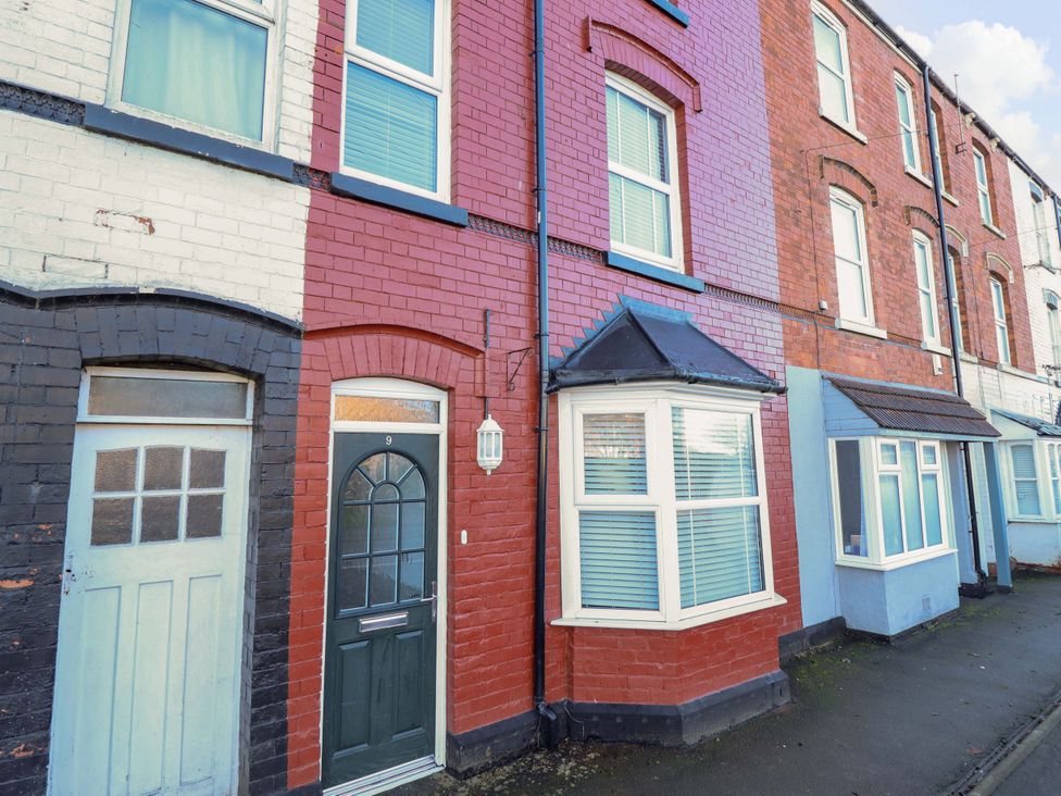 A residential building with a front door and multiple windows at 9 Alford Road