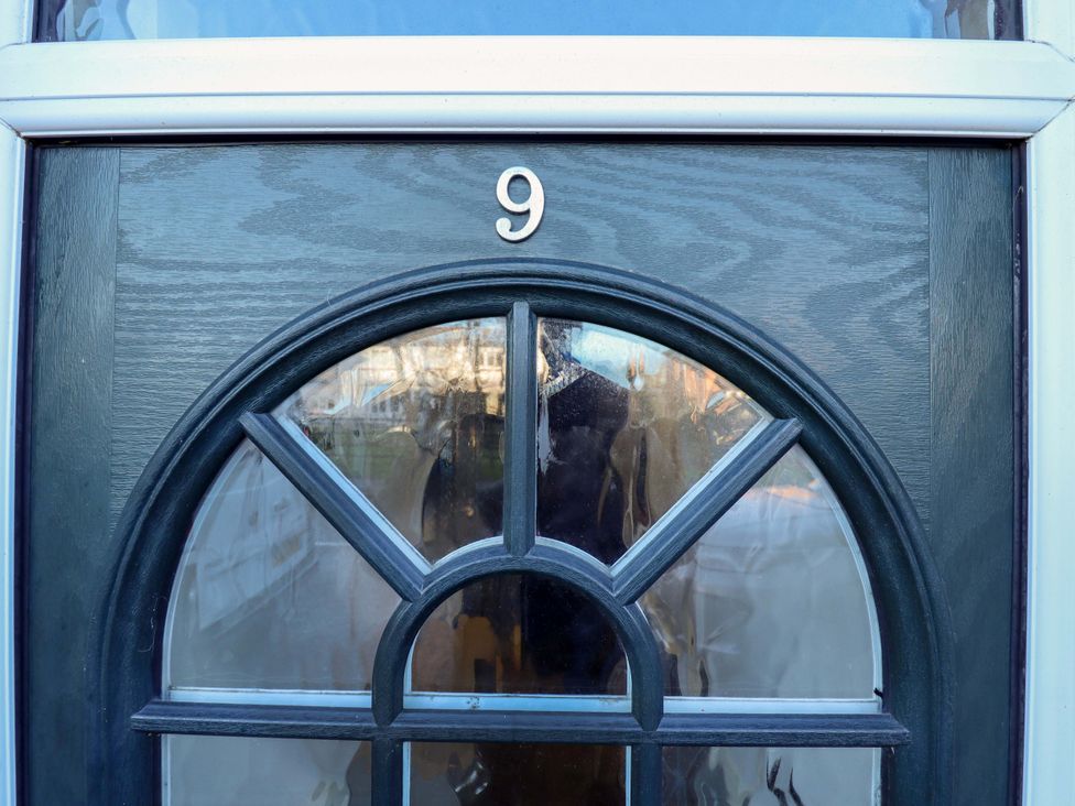A door with glass window and number 9 at 9 Alford Road