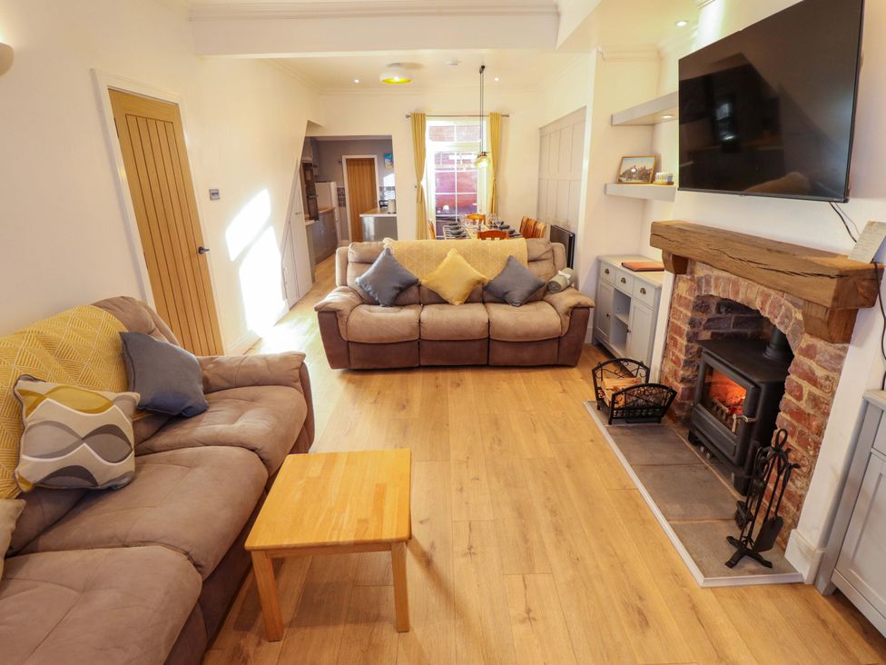 A living room with a fireplace and seating area at 9 Alford Road