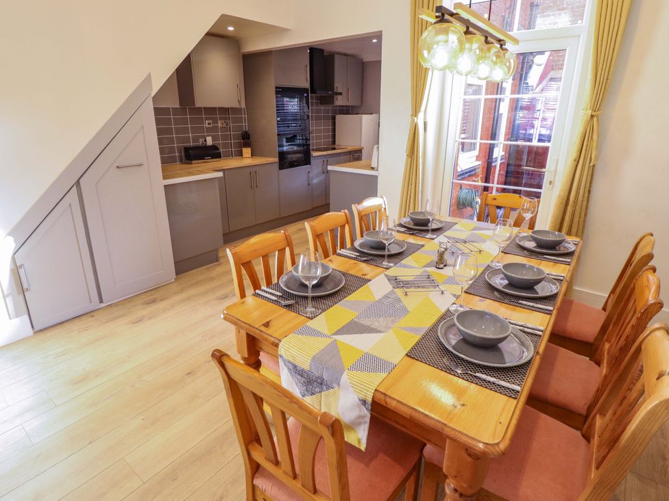 A dining room with a table and chairs at 9 Alford Road
