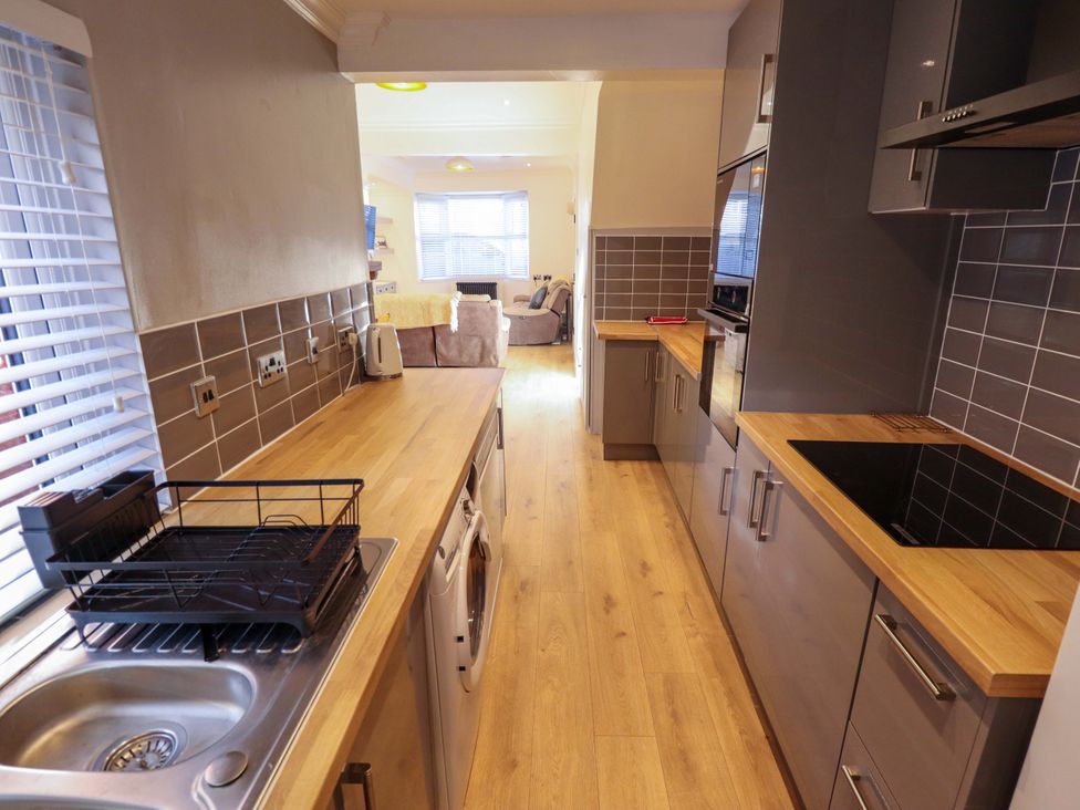 A kitchen with a sink and dish rack at 9 Alford Road