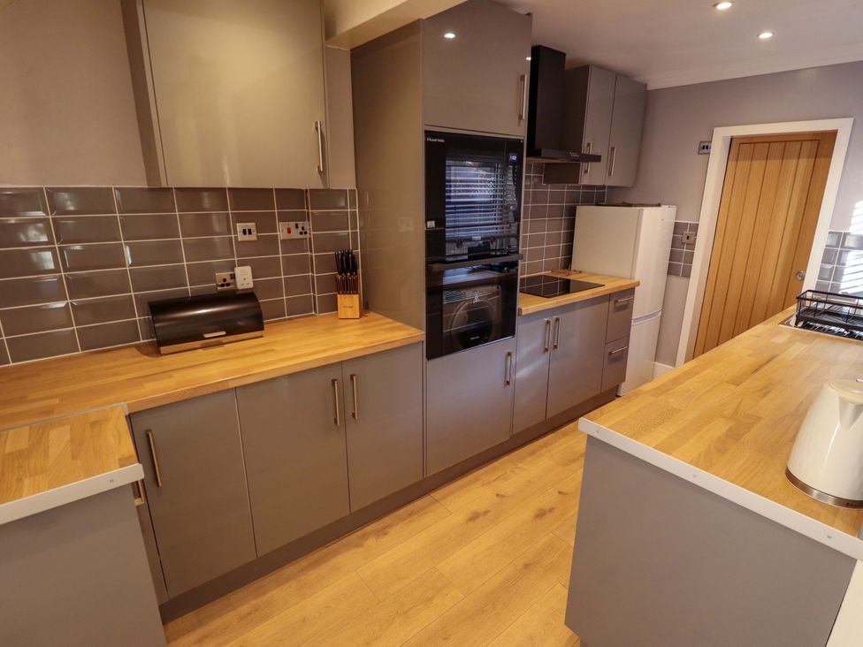 A kitchen with cabinets and appliances at 9 Alford Road