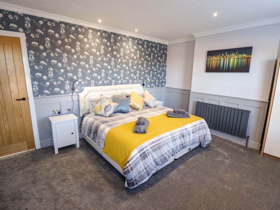 A bedroom with a bed and nightstand at 9 Alford Road