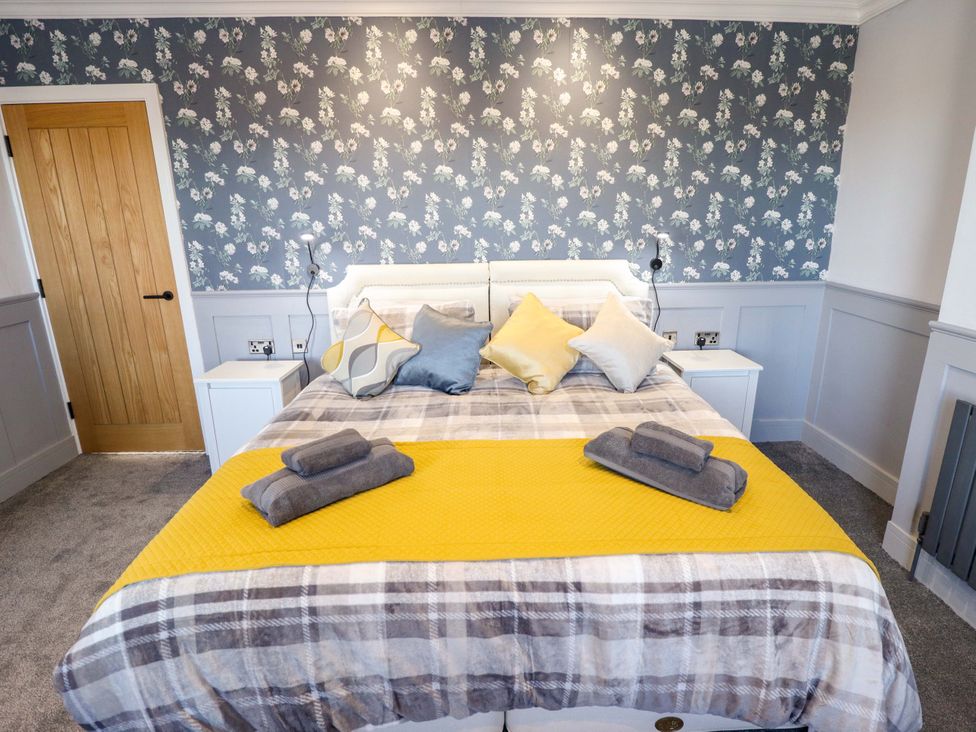 A bedroom with a bed and decorative bedding at 9 Alford Road