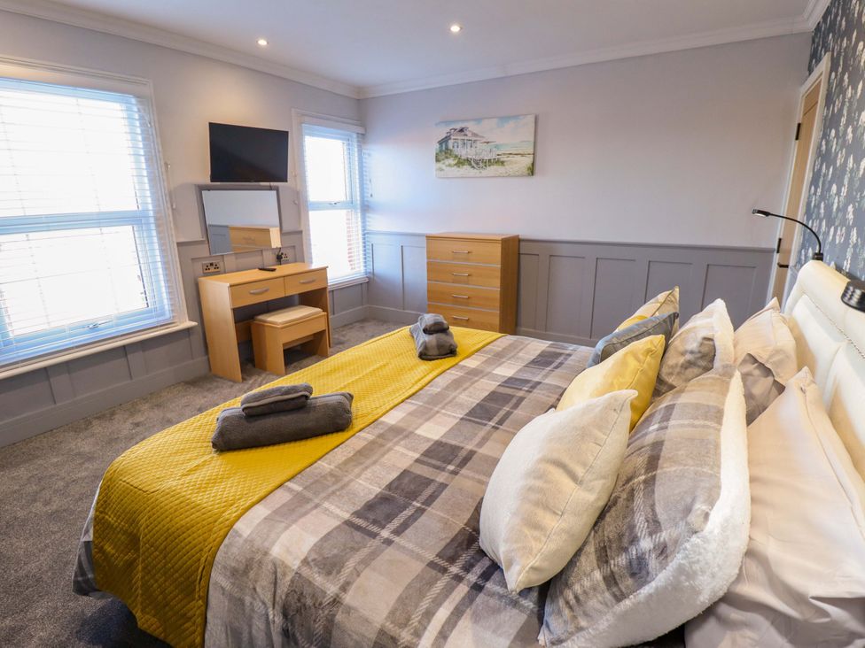 A bedroom with a bed, desk, and television at 9 Alford Road 