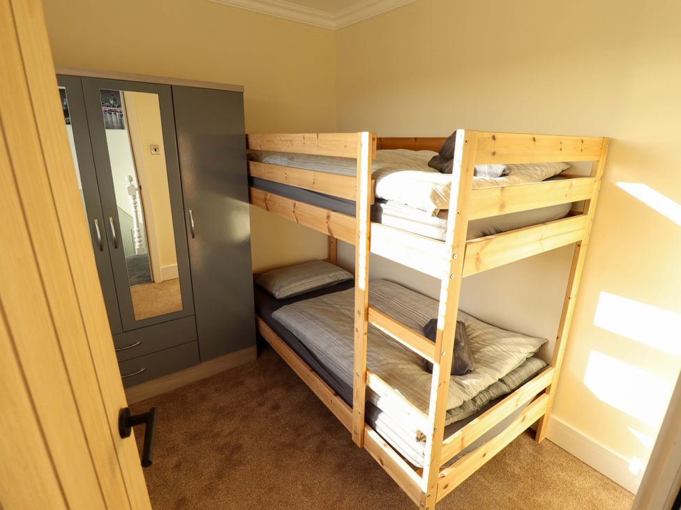 A bedroom with a bunk bed and a wardrobe at 9 Alford Road