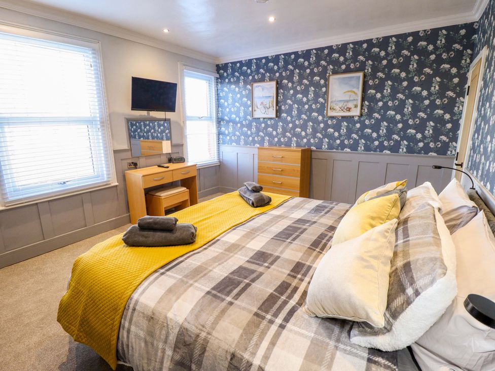 A bedroom featuring a bed, television, and chest of drawers at 9 Alford Road
