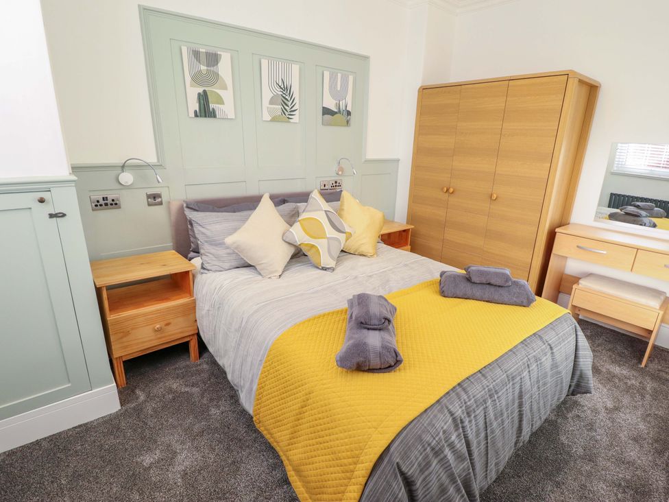 A bedroom with a bed and wardrobe at 9 Alford Road