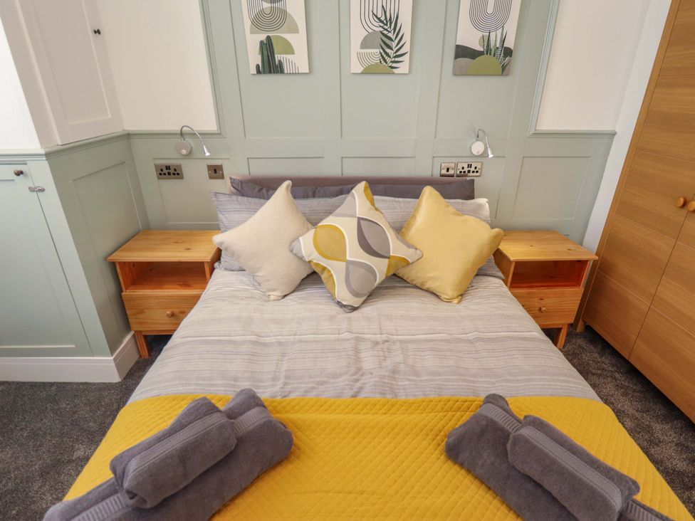 A bedroom with a bed and nightstands at 9 Alford Road 