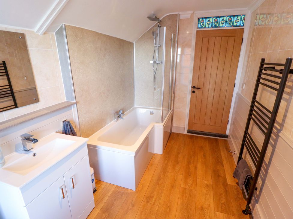 A bathroom with a bathtub and sink at 9 Alford Road