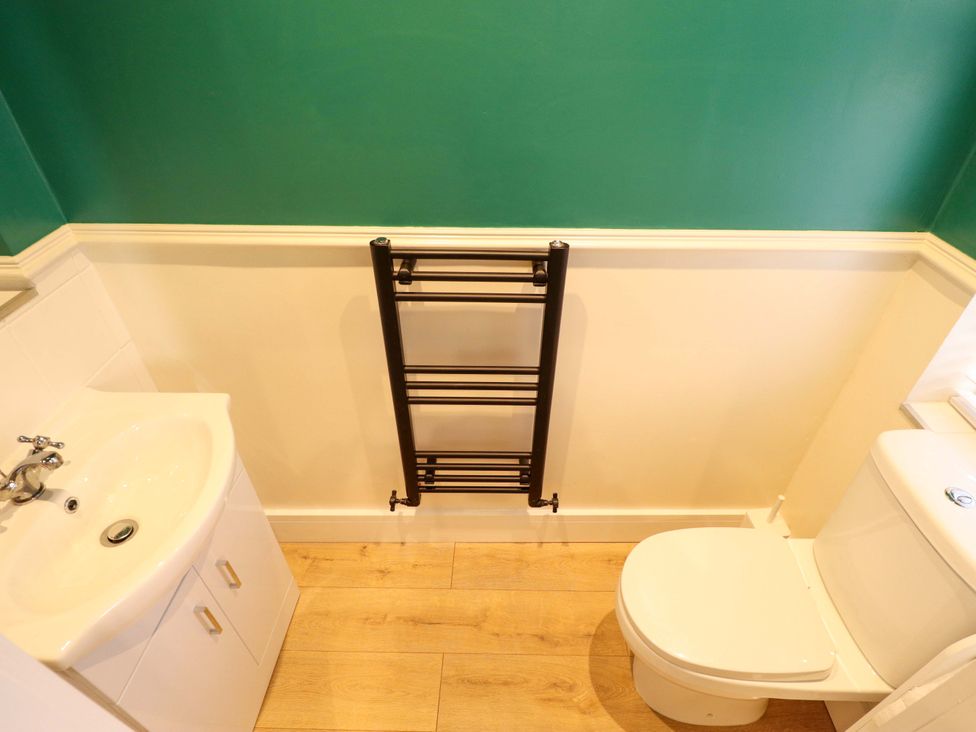 A bathroom with a sink, toilet, and a towel radiator at 9 Alford Road