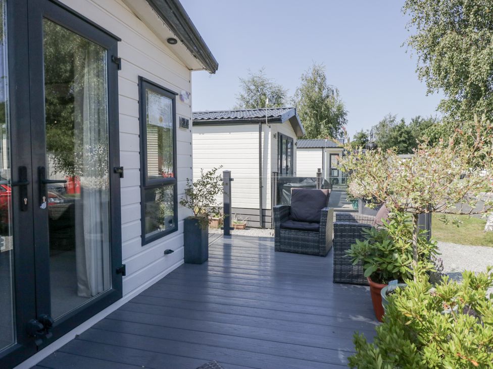 An outdoor area with seating and plants at Lilac Lodge Carnforth