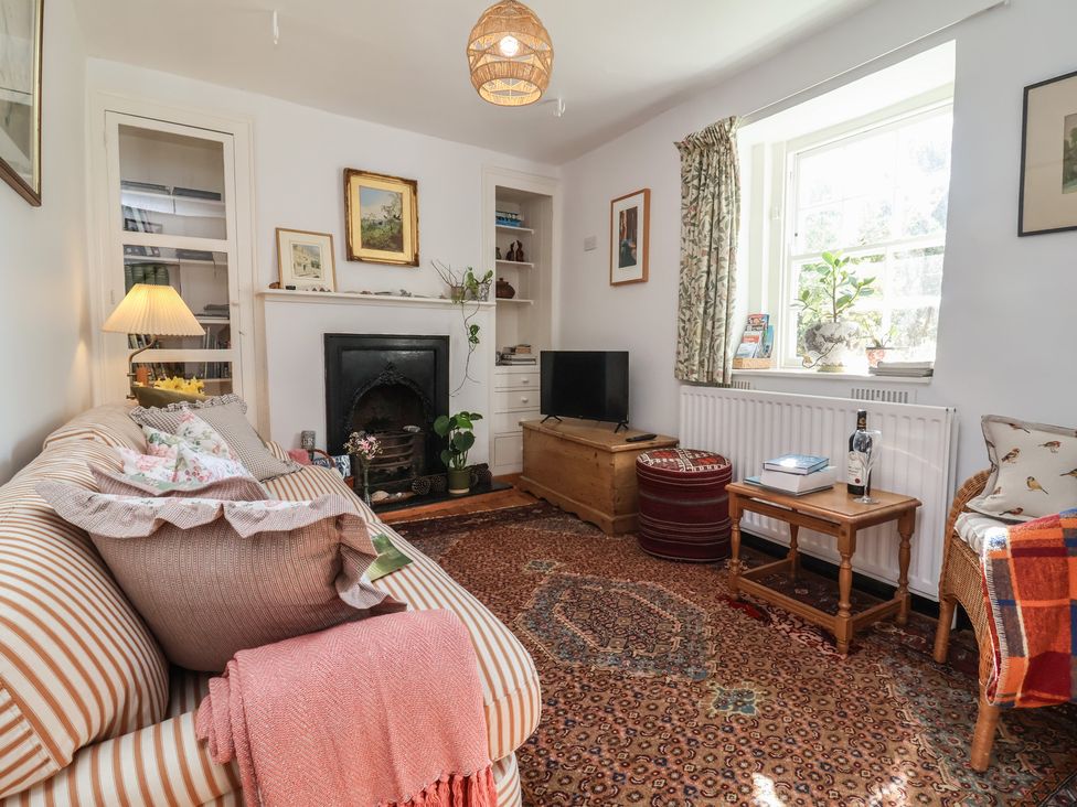 A living room with a fireplace and a sofa at Blackbird Cottage Northam