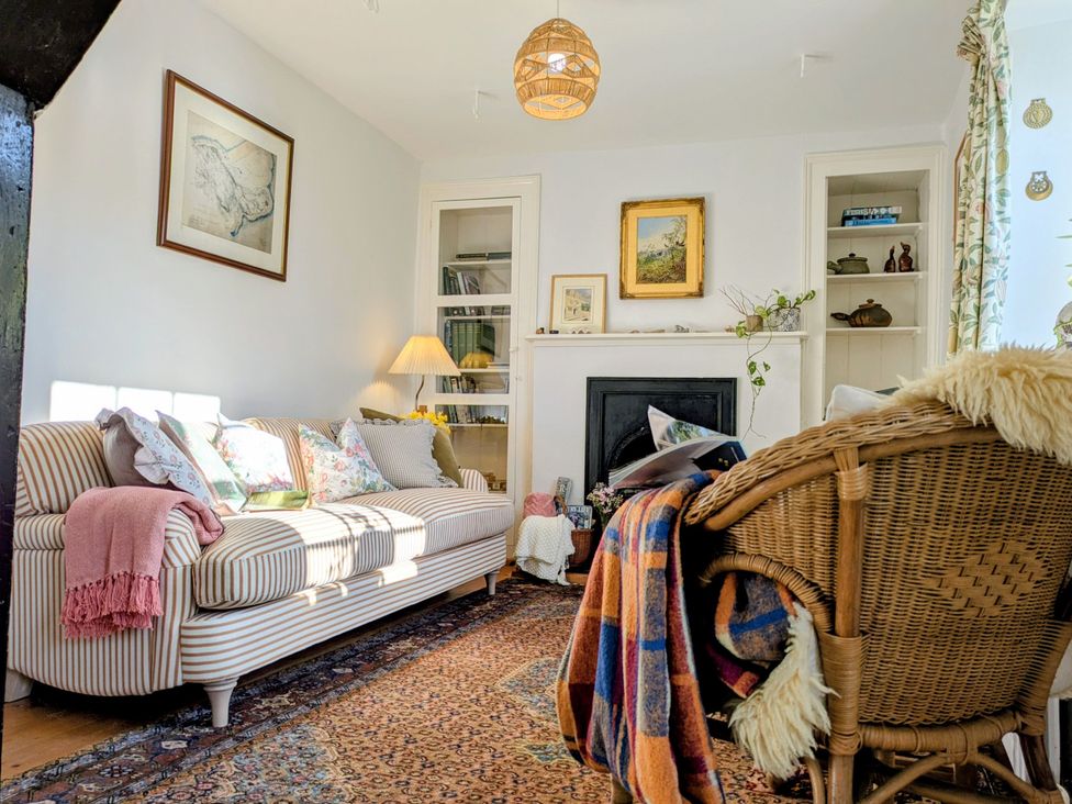 A living room with a sofa and armchair at Blackbird Cottage Northam