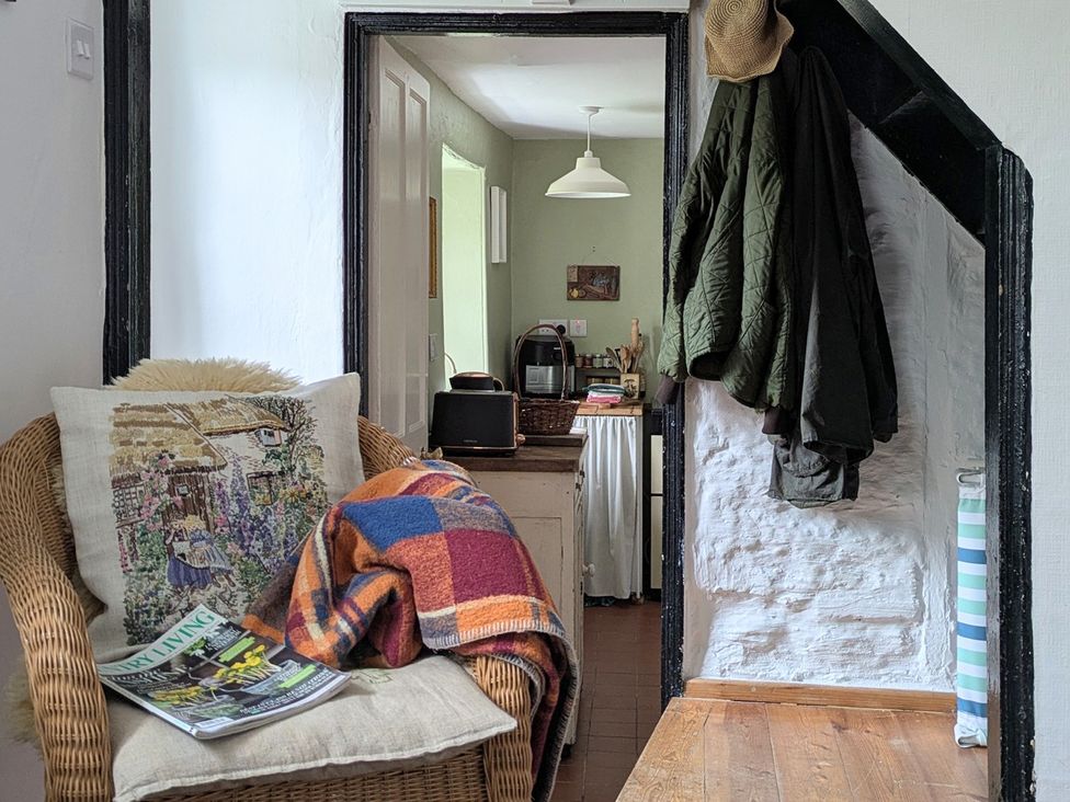 A hallway with a sofa and magazine at Blackbird Cottage Northam