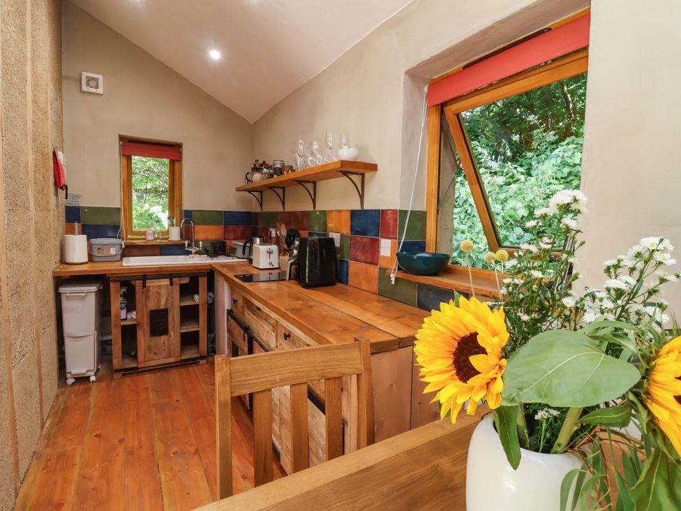 A kitchen with wooden countertops and appliances at Brambly Cabin in Crediton