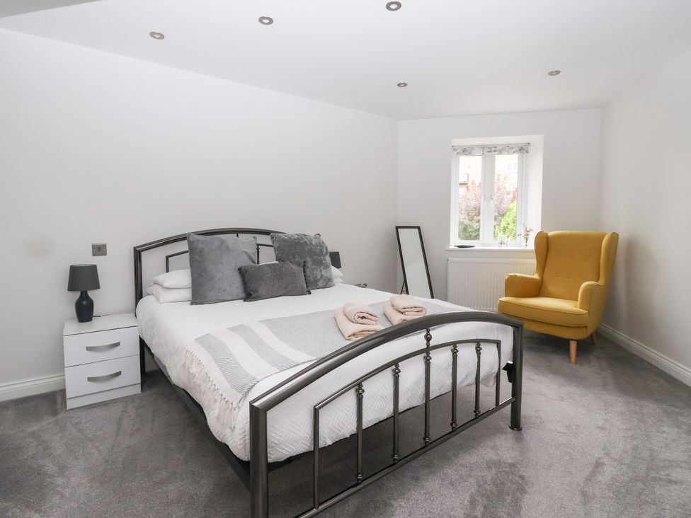 A bedroom with a bed and a chair at Waters View in Skipton