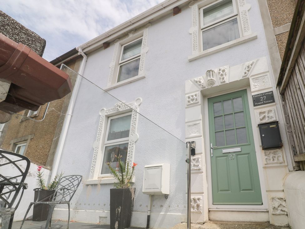 The exterior of Foundry Cottage with a door and windows in Hayle