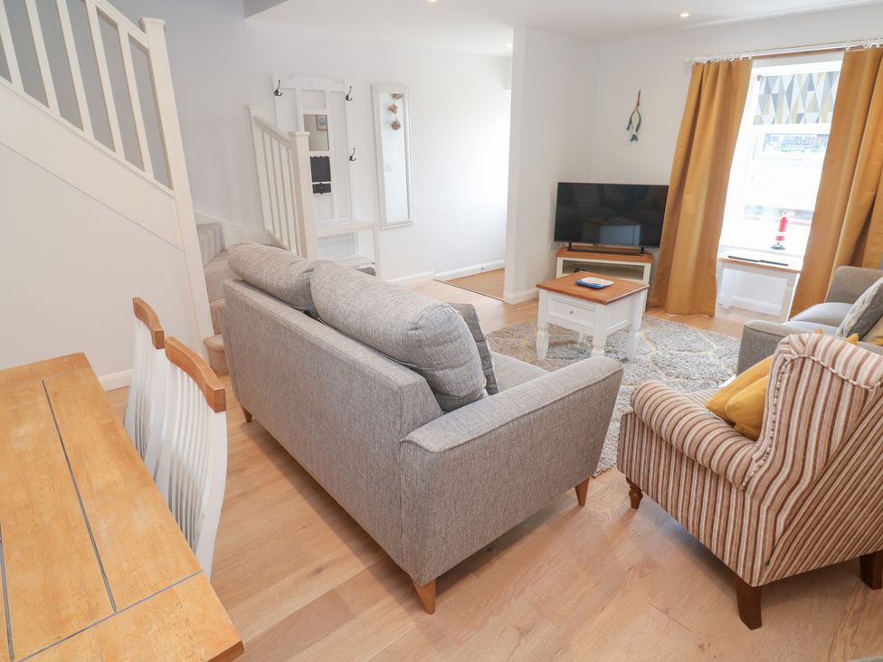 A living room with a sofa and a television at Foundry Cottage In Hayle Harbour in Hayle
