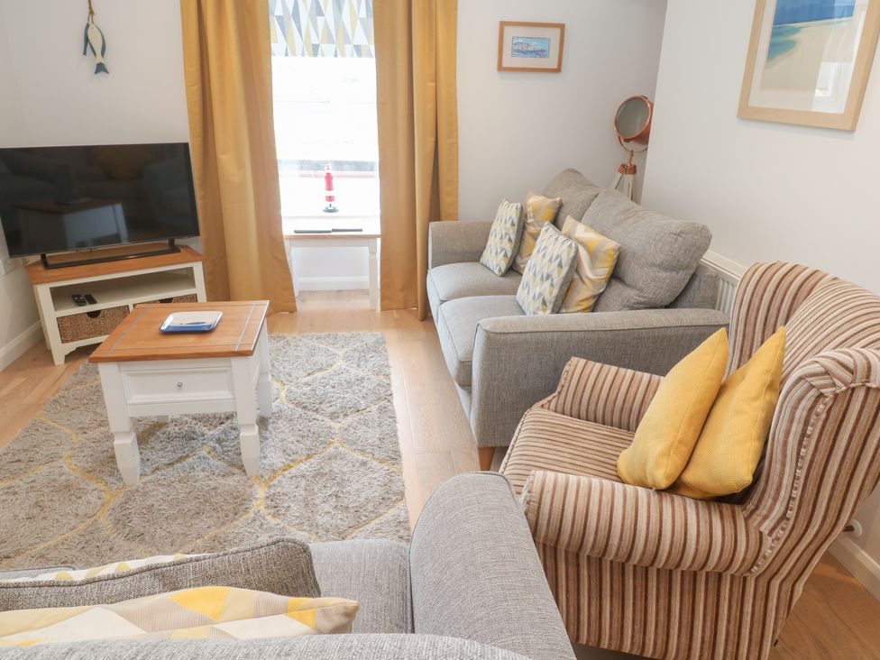 A living room with a television and sofa at Foundry Cottage In Hayle Harbour Hayle