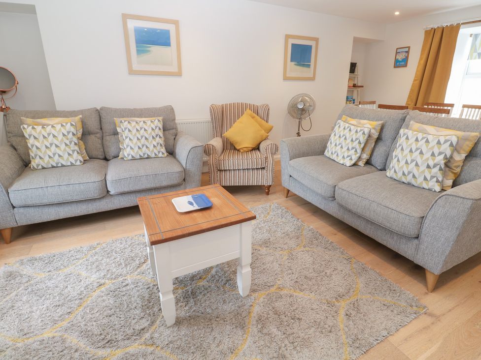 A living room with sofas and a coffee table at Foundry Cottage In Hayle Harbour Hayle