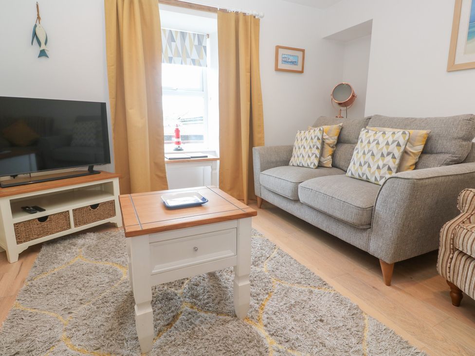 A living room with a sofa and television at Foundry Cottage In Hayle Harbour, Hayle