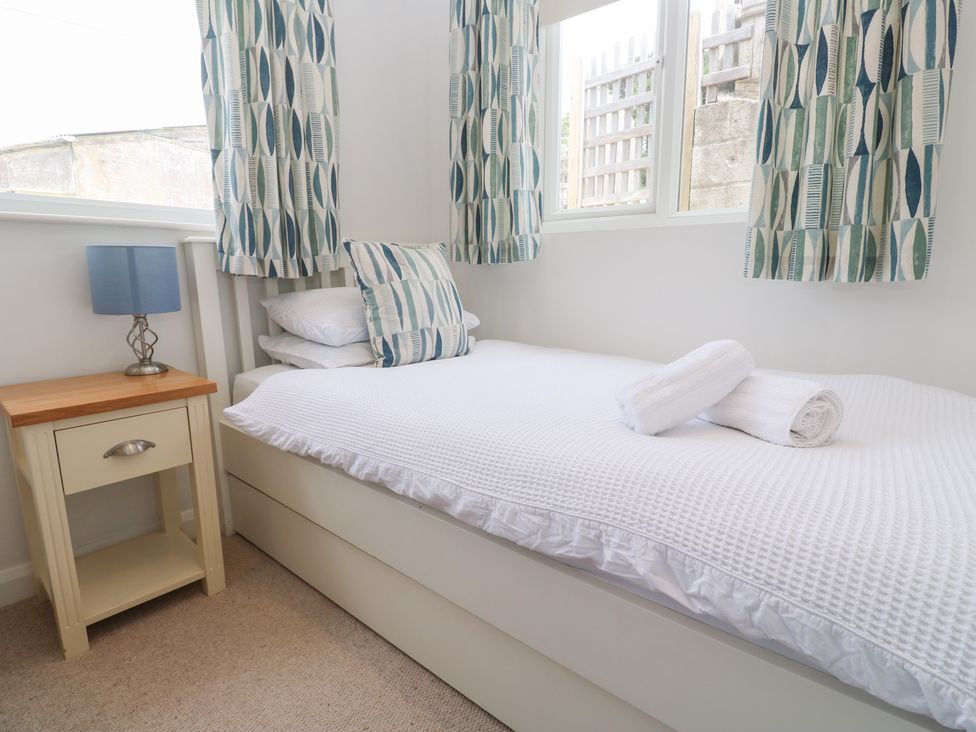 A bedroom with a single bed and bedside table at Foundry Cottage In Hayle Harbour Hayle