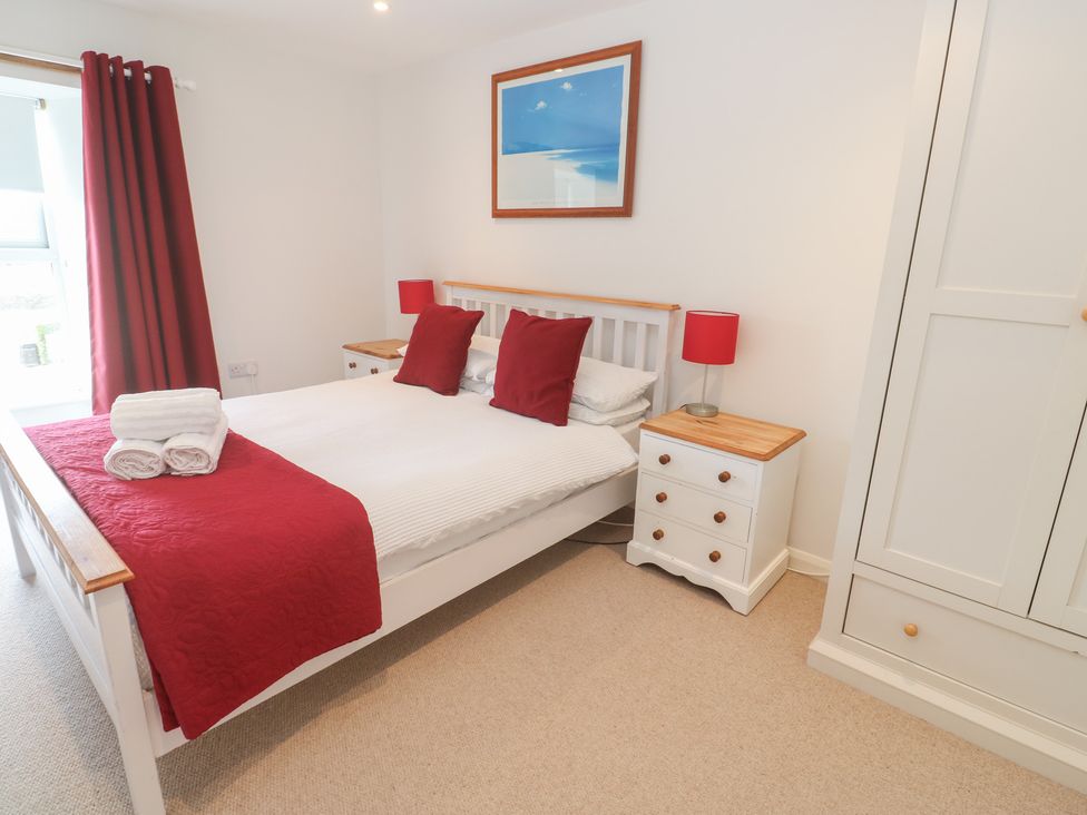 A bedroom with a bed and bedside tables at Foundry Cottage In Hayle Harbour, Hayle
