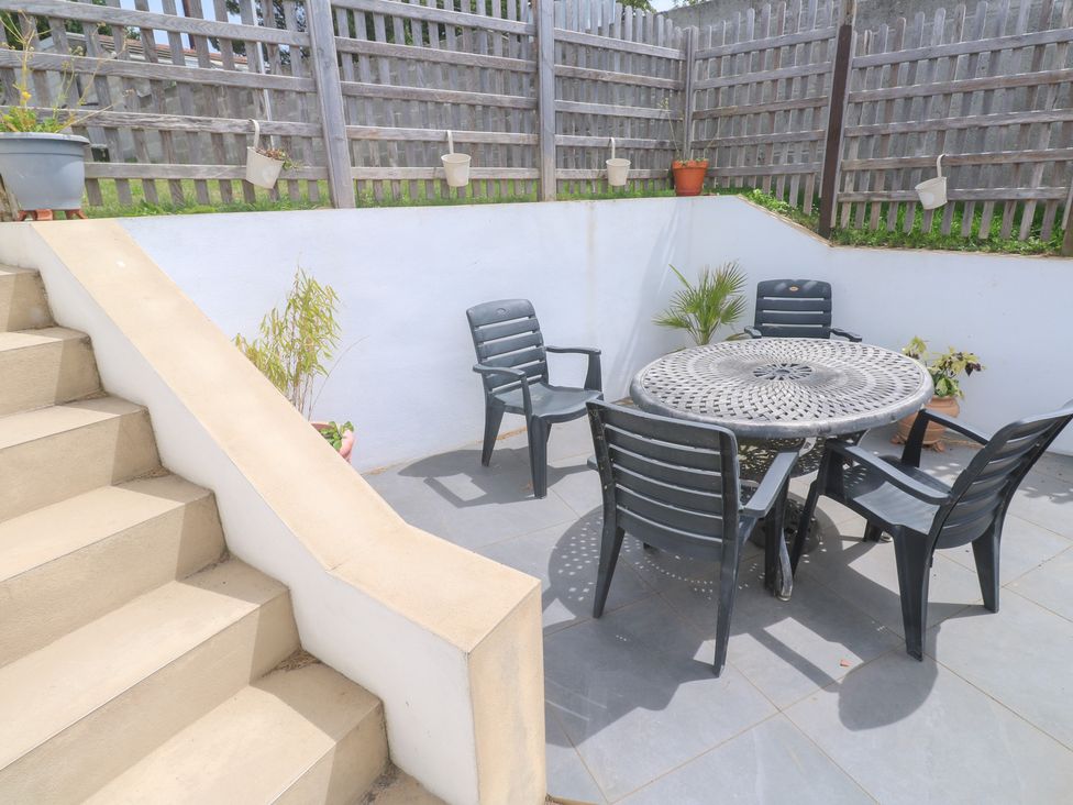 A patio area with a table and chairs at Foundry Cottage In Hayle Harbour, Hayle