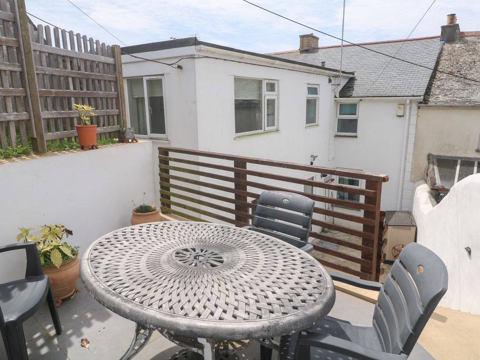 An outdoor area with a table and chairs at Foundry Cottage In Hayle Harbour Hayle
