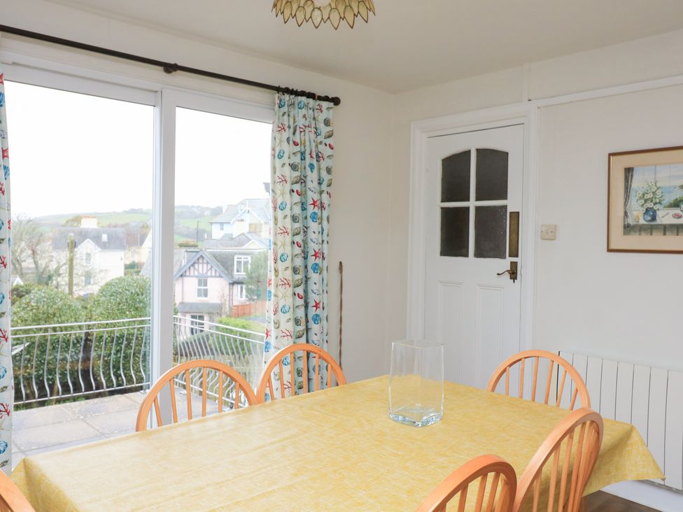 A dining room with a table and chairs at Waders in Salcombe