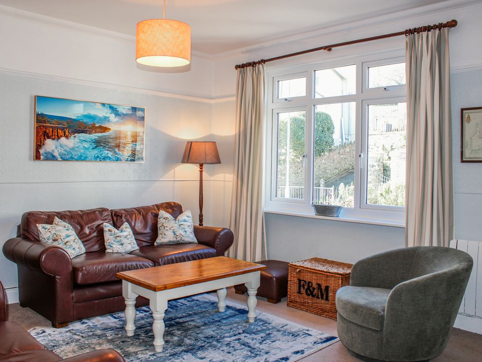 A living room with a sofa and coffee table at Waders in Salcombe