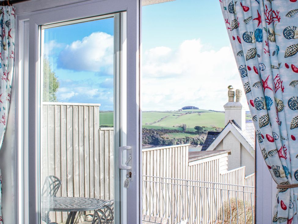 A door and outdoor seating area with view at Waders in Salcombe