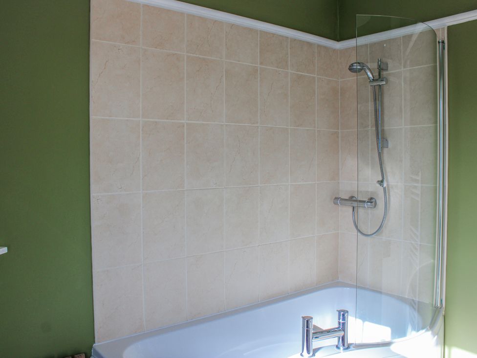 A bathroom with a bathtub and shower at Waders in Salcombe