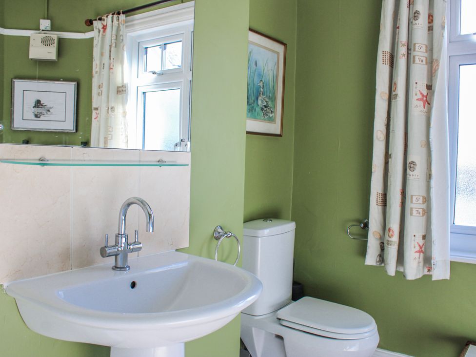 A bathroom with a sink and toilet at Waders in Salcombe