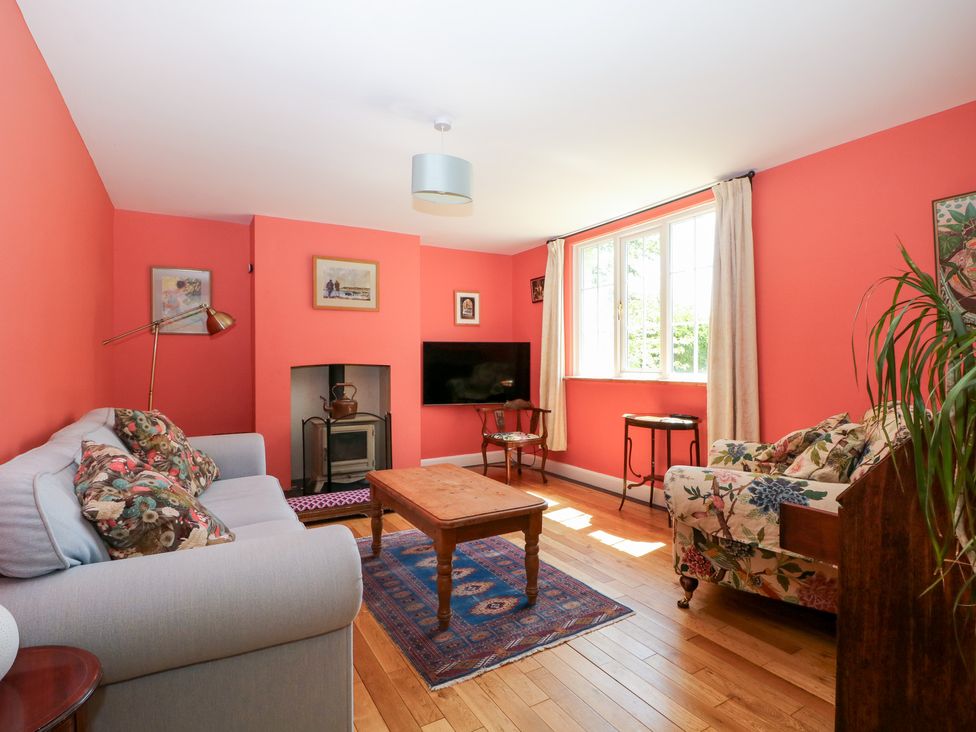 A living room with a sofa and coffee table at Cherry Garden Cottage Sandhurst