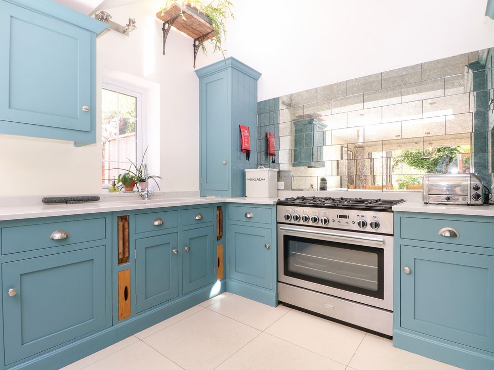 A kitchen with cabinets and appliances at Cherry Garden Cottage in Sandhurst