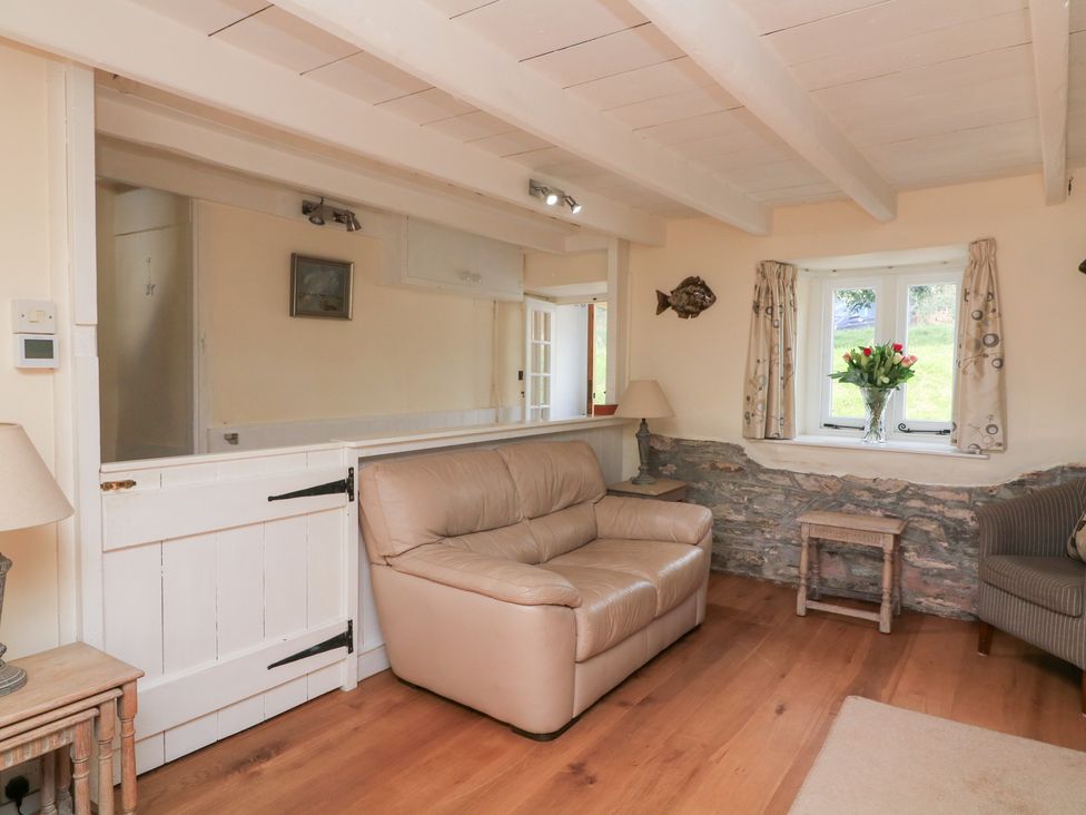 A living room with a sofa and a table at Wayside near Kingsbridge